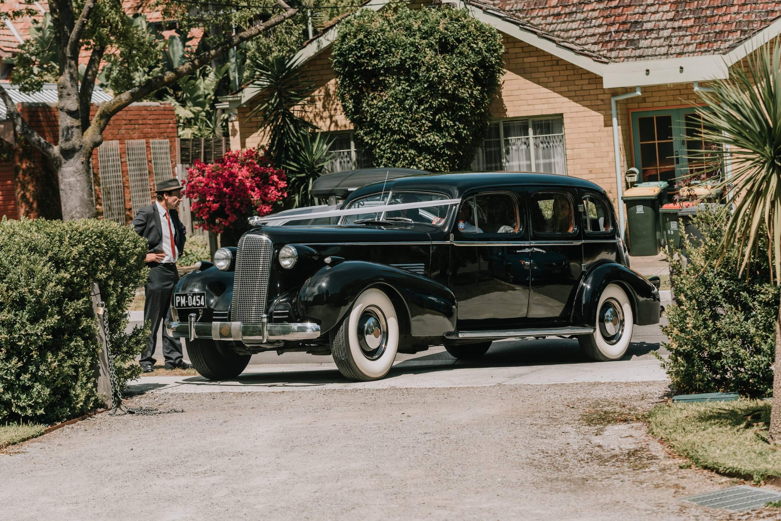 This vintage black cadillac is the couples choice as wedding car. Captured by Black Avenue Productions