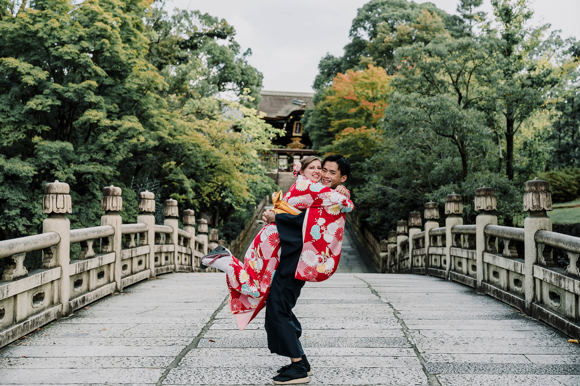 Beautiful shot of the couple in traditional kimono by a Japanese Bridge by Black Avenue Productions