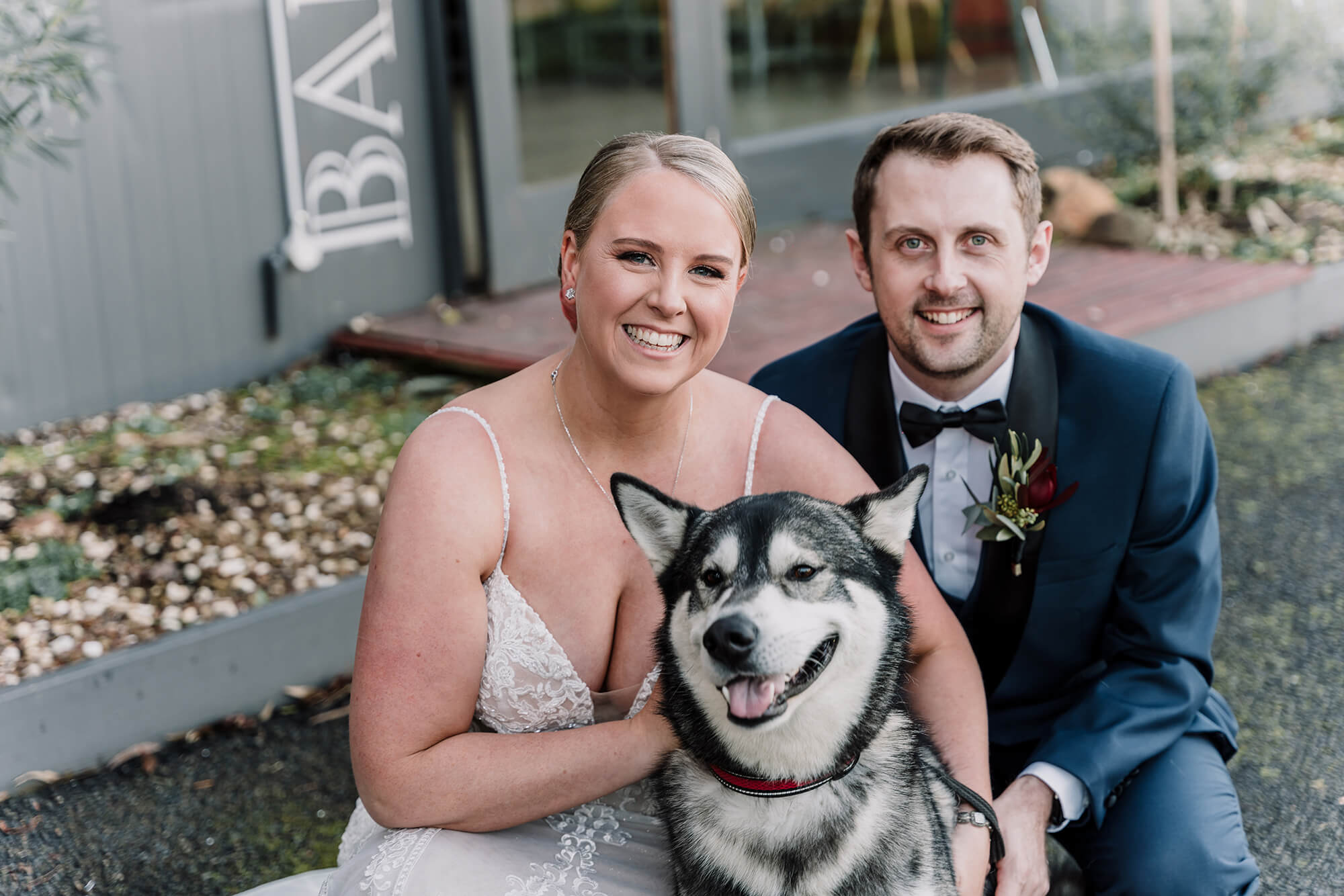 Bride and groom smiles with their beautiful dog by Black Avenue Productions