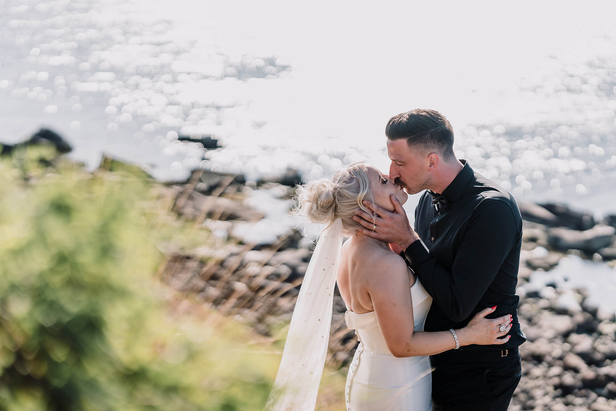Engagement Photo Ideas, groom kisses her bride by the sea by Black Avenue Productions