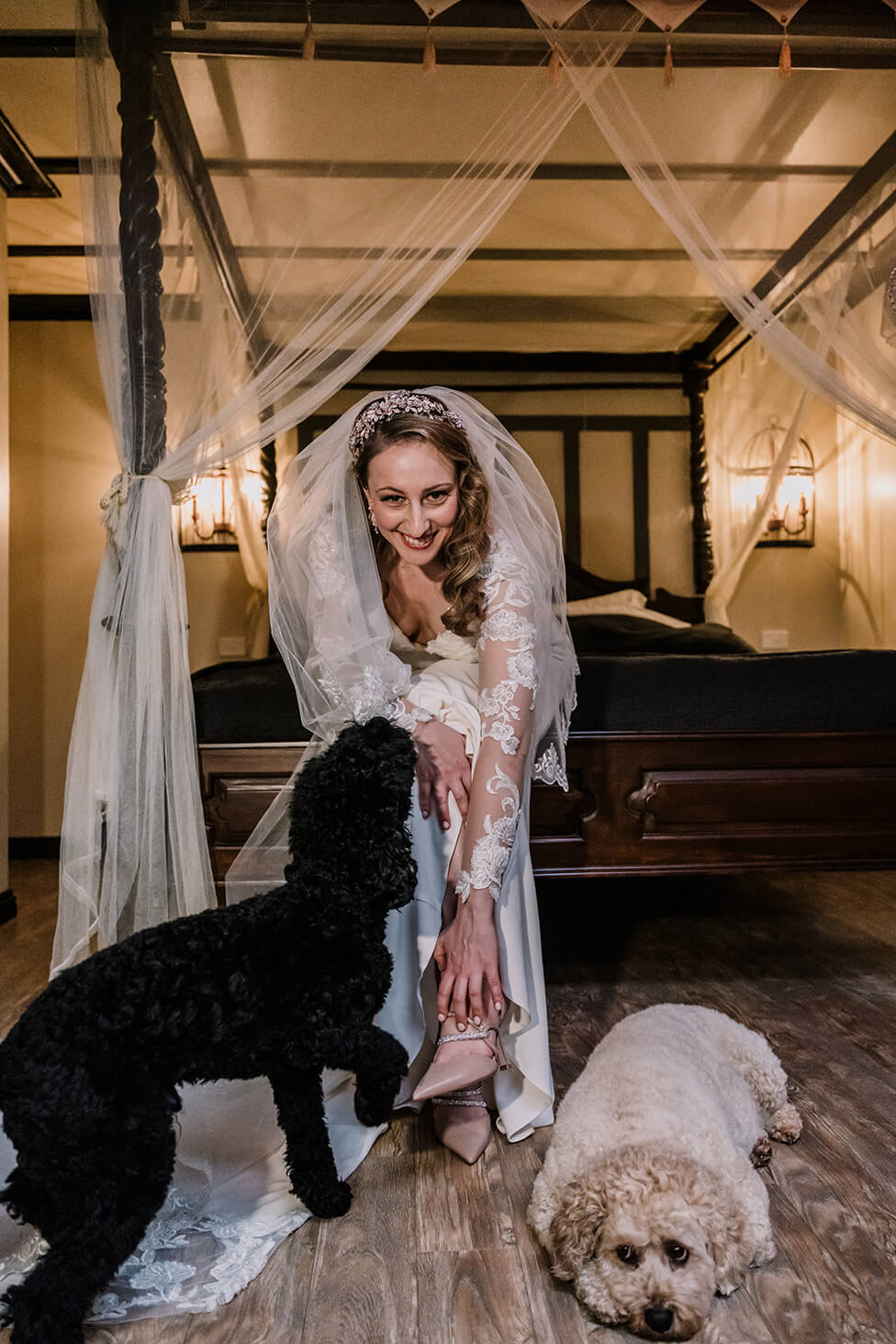 Awesome Ways to include your pet, bride poses with her lovely dogs by the bed, captured by Black Avenue Productions