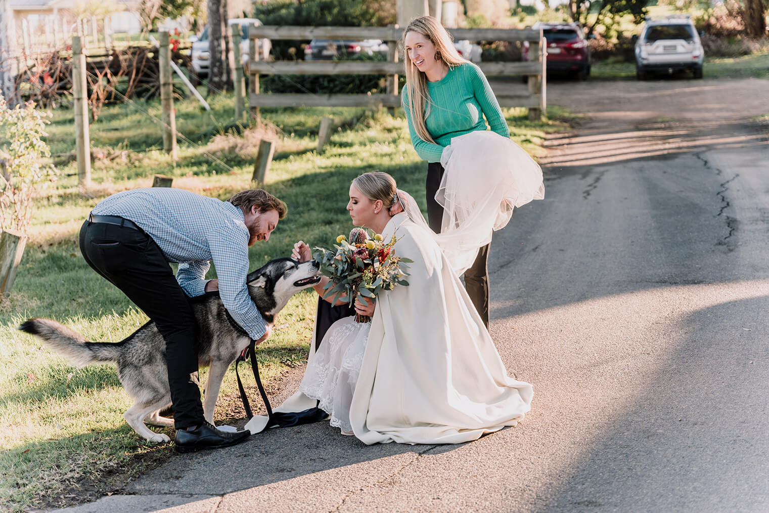 Awesome Ways to include your pet - Beautiful bride pets her lovely dog before the wedding starts, captured by Black Avenue Productions