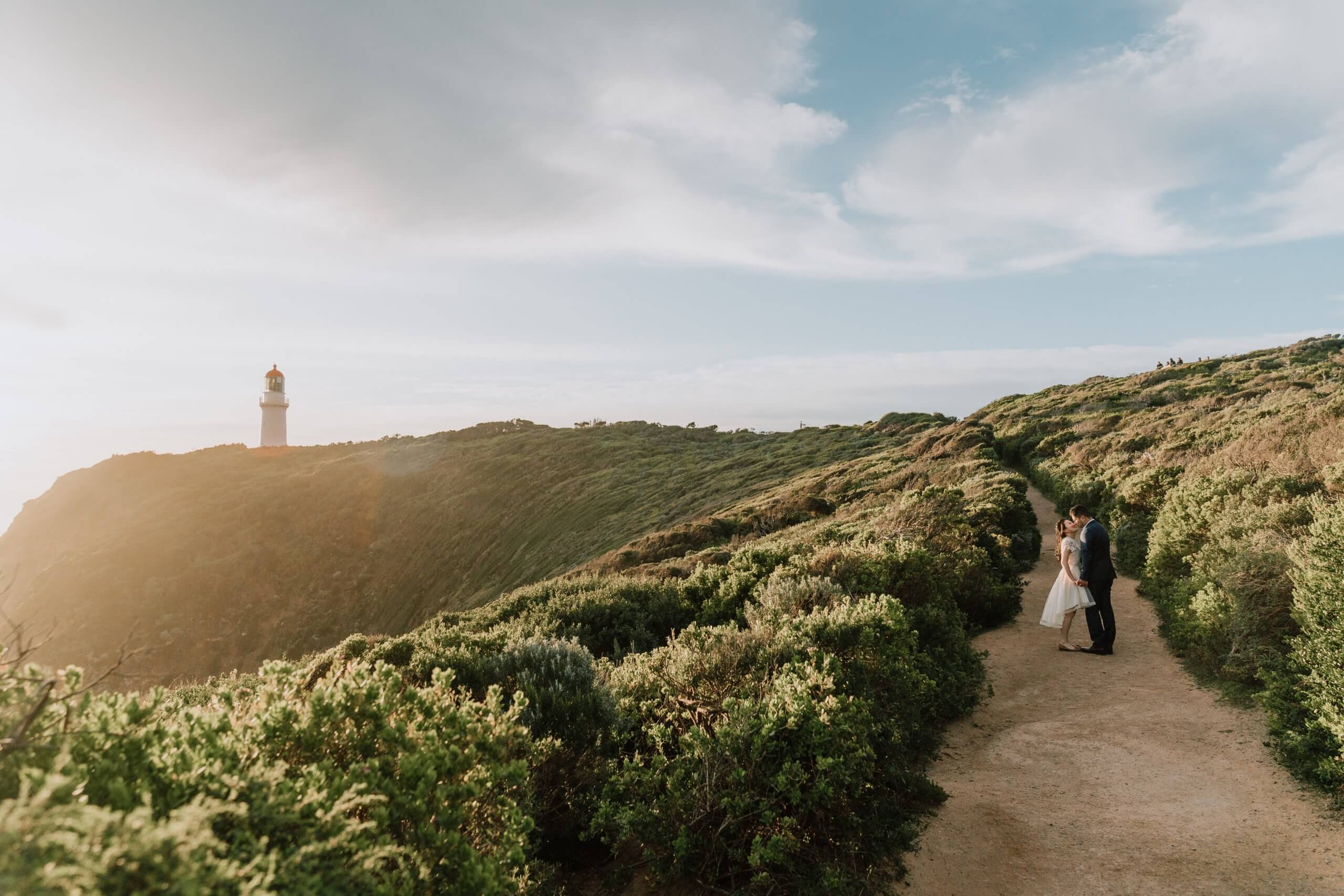 Couple poses with a majestic view of the Cape Schanck Lighthouse Reserve as the backdrop.