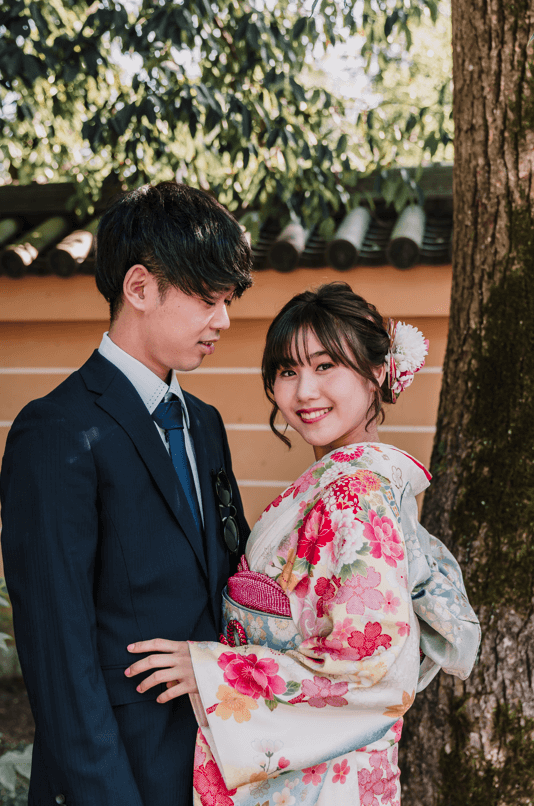 Japanese couple posing in front of the camera in their traditional Japanese clothes.