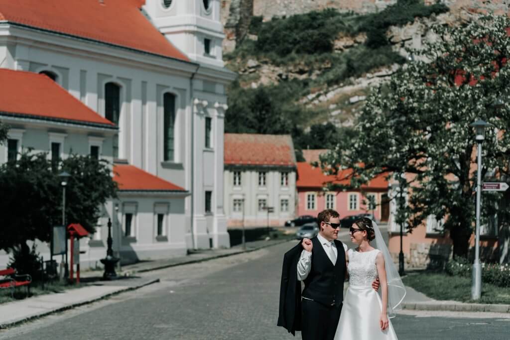 Bride and Groom looking chic in their wedding clothes and matching sunglasses.