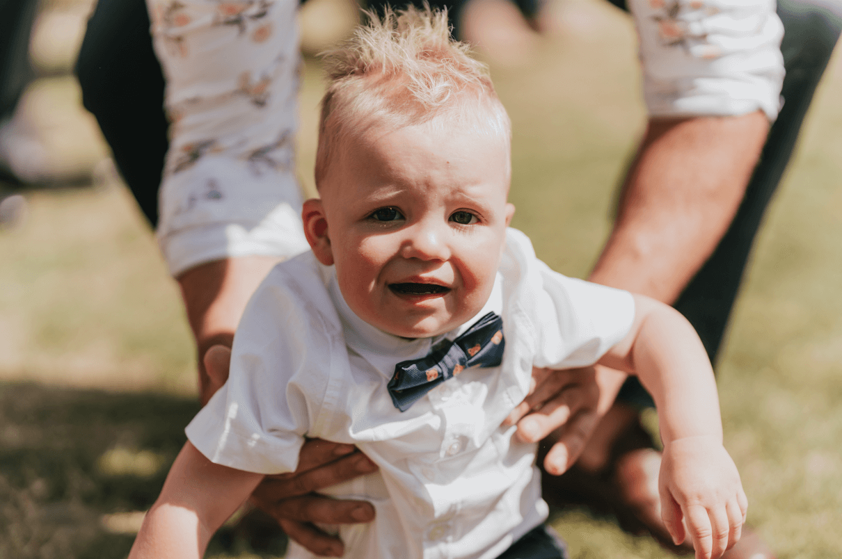 The photographer captures the crying face of a baby during the ceremony.
