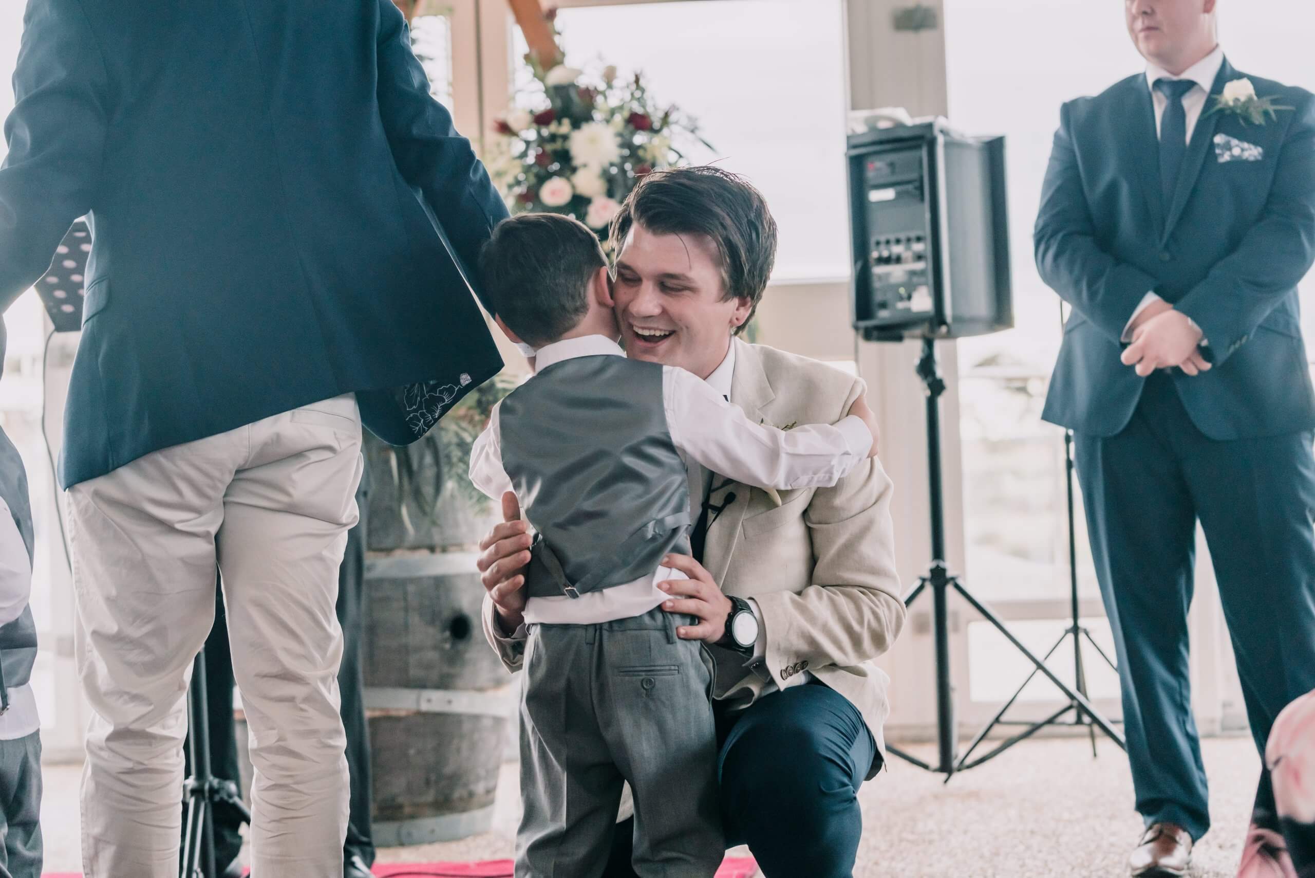 Groom hugs his nephew when he reaches the altar.