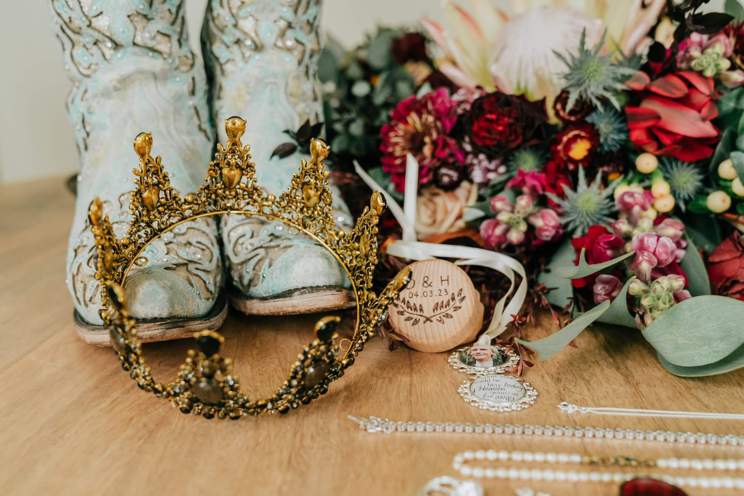 Beautiful wedding details - a crown, accessories, blue boots, and rustic wedding flowers.