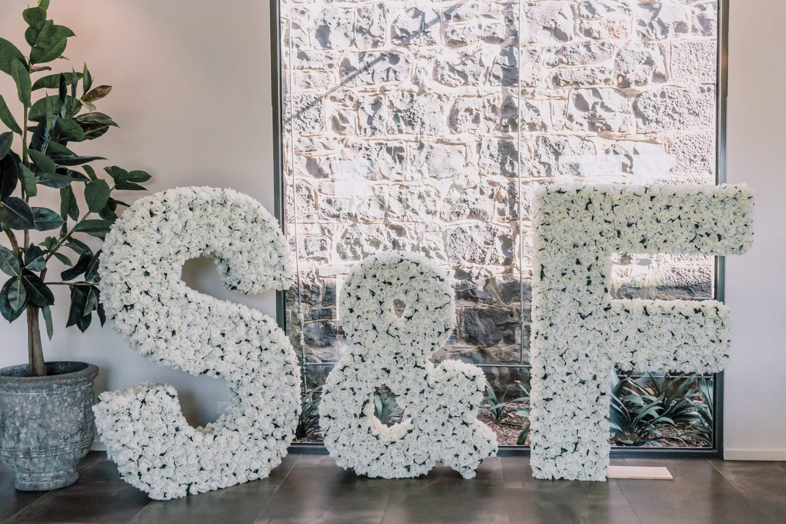 Big letters made of flowers at S & F's wedding.
