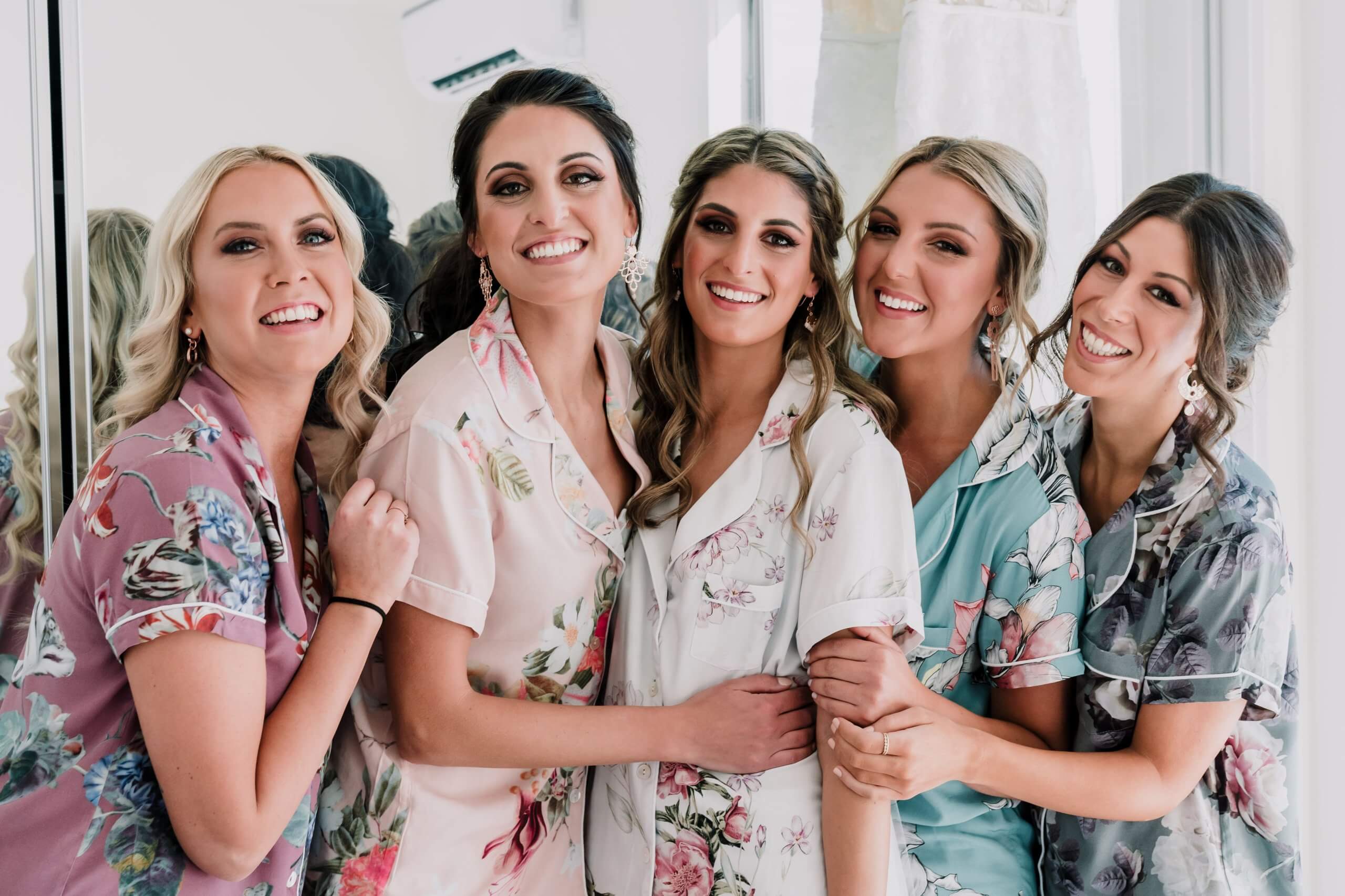 Customise Your Wedding - Bride and her bridesmaids during her getting-ready shoot, wearing matching floral pajamas.
