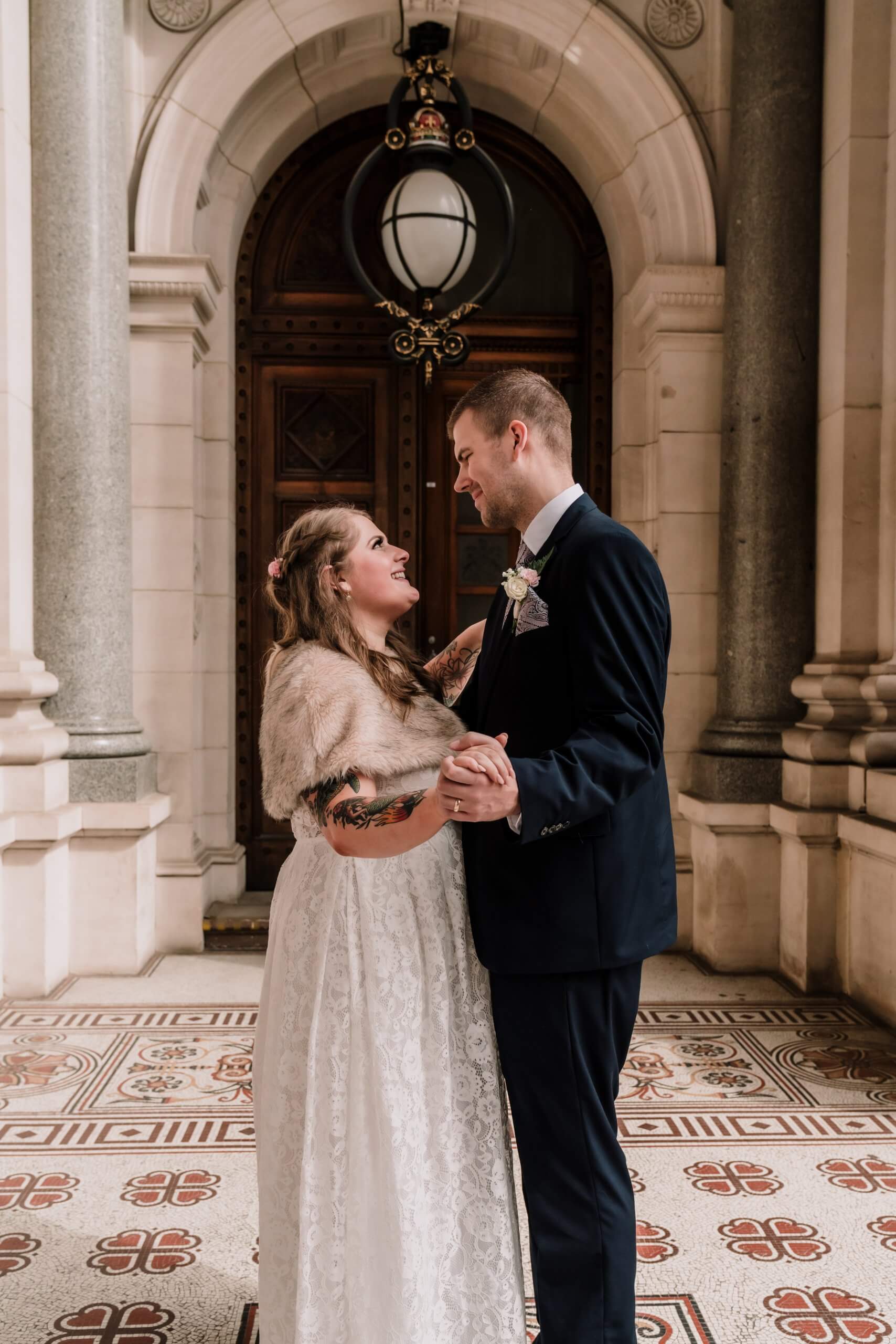 Narrative Portraiture - Bride and Groom slow dancing with each other in an ornate hallway