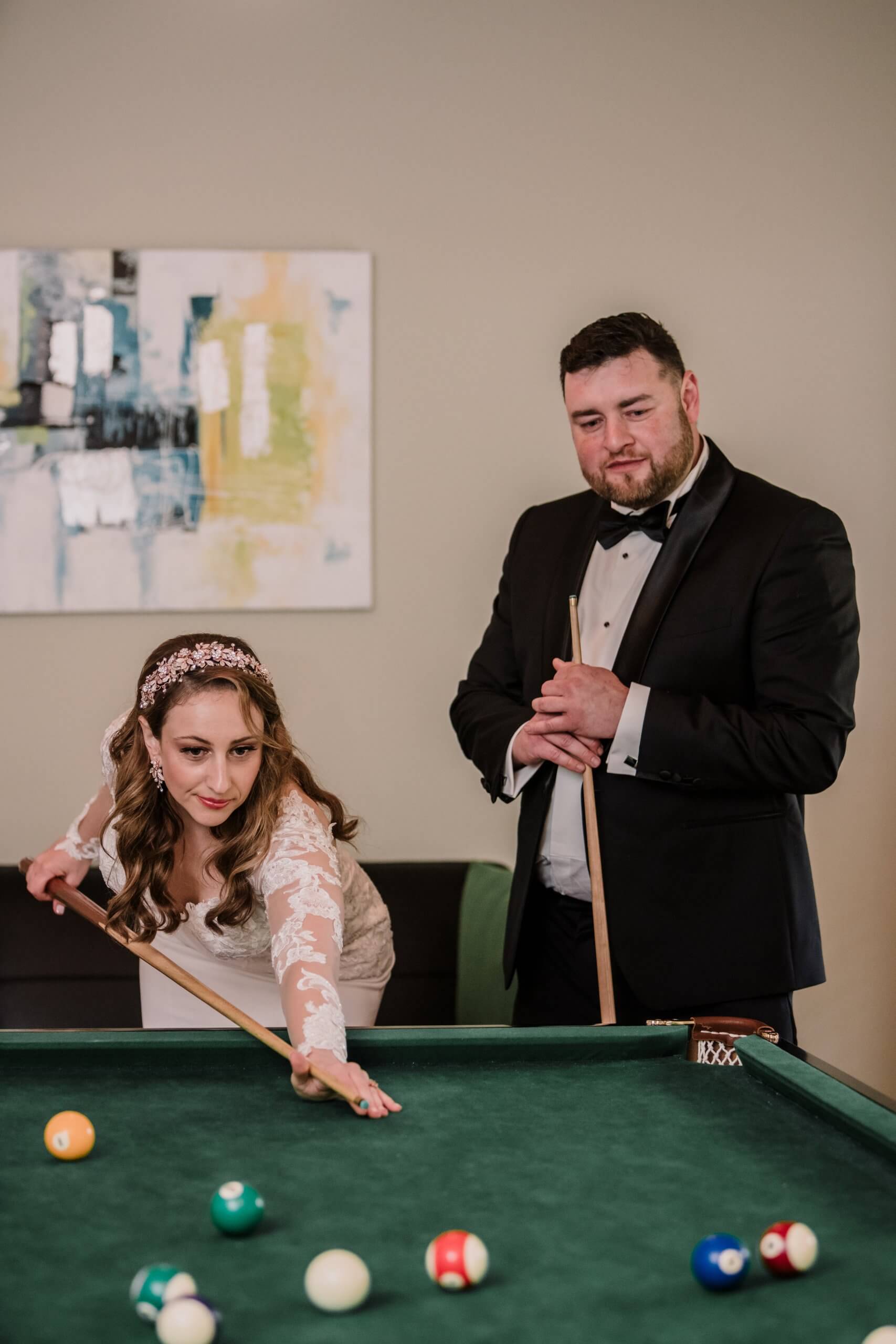 The bride and groom playing pool after the ceremony at Nathania Springs