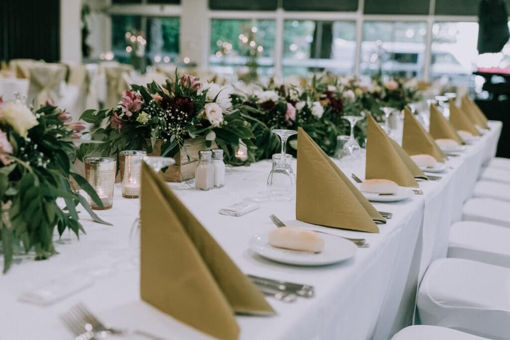 Detail shot of the reception venue with the folded napkin for the guests