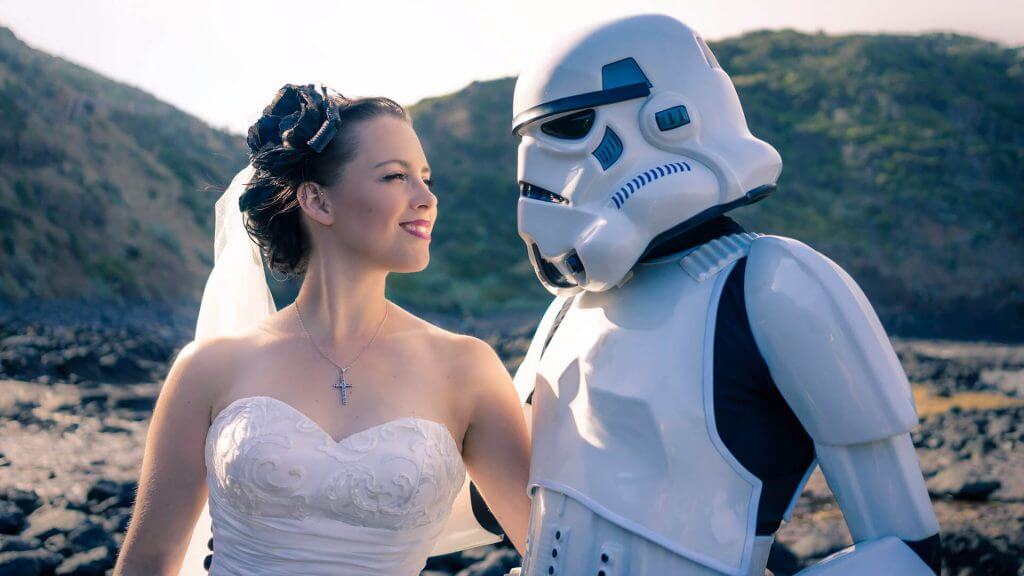 Black Avenue Productions took the image of a storm trooper looking at his stunning wife in her sweetheart neckline wedding dress in Mornington peninsula